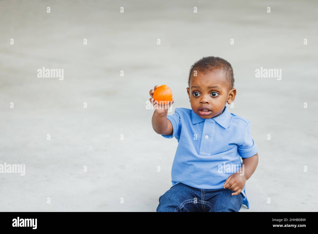 A cute one year old toddler almost preschool age African-American boy
