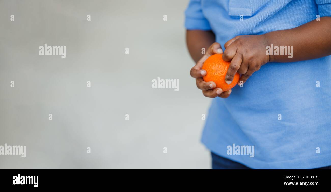 A cute one year old toddler African-American boy holding a healthy