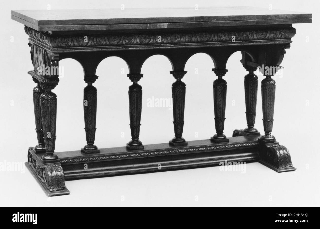 Draw-top table 1560–90, with later restorations French In the sixteenth century, simple planks resting on trestles gave way to tables with sturdy, fixed supports of varying design. Following an architecturally inspired scheme that gained favor during the reign of Henri II (1547–59), this example has a rectangular top supported by leaf-carved balusters that form an arcade. Panels at either end feature personifications of seasons: Spring, with flowers, and Summer, with wheat.. Draw-top table  197166 Stock Photo