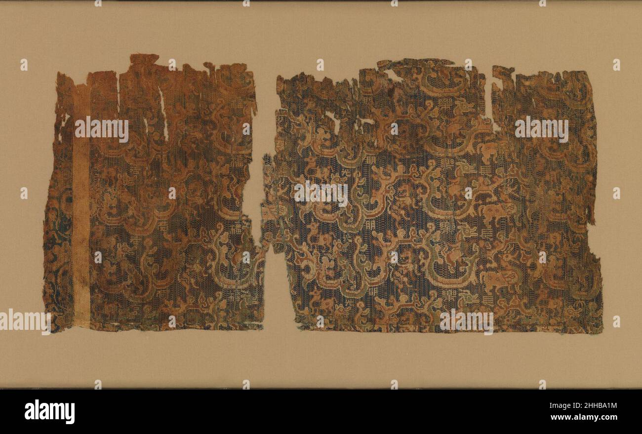 Textile with animals and woven inscription 1st�C3rd century China On this colorful textile, several lively creatures climbing cloudlike mountains are interspersed with Chinese characters that form an incomplete auspicious inscription. The pattern of animals and clouds was popular on Chinese silks from the Han to the Jin dynasty (ca. 1st�C3rd century). Textiles with such patterns have been found at archaeological sites all over China, including in the far west, and were often referred to in contemporary documents by complete or partial inscriptions. The inscription on this work includes the chara Stock Photo