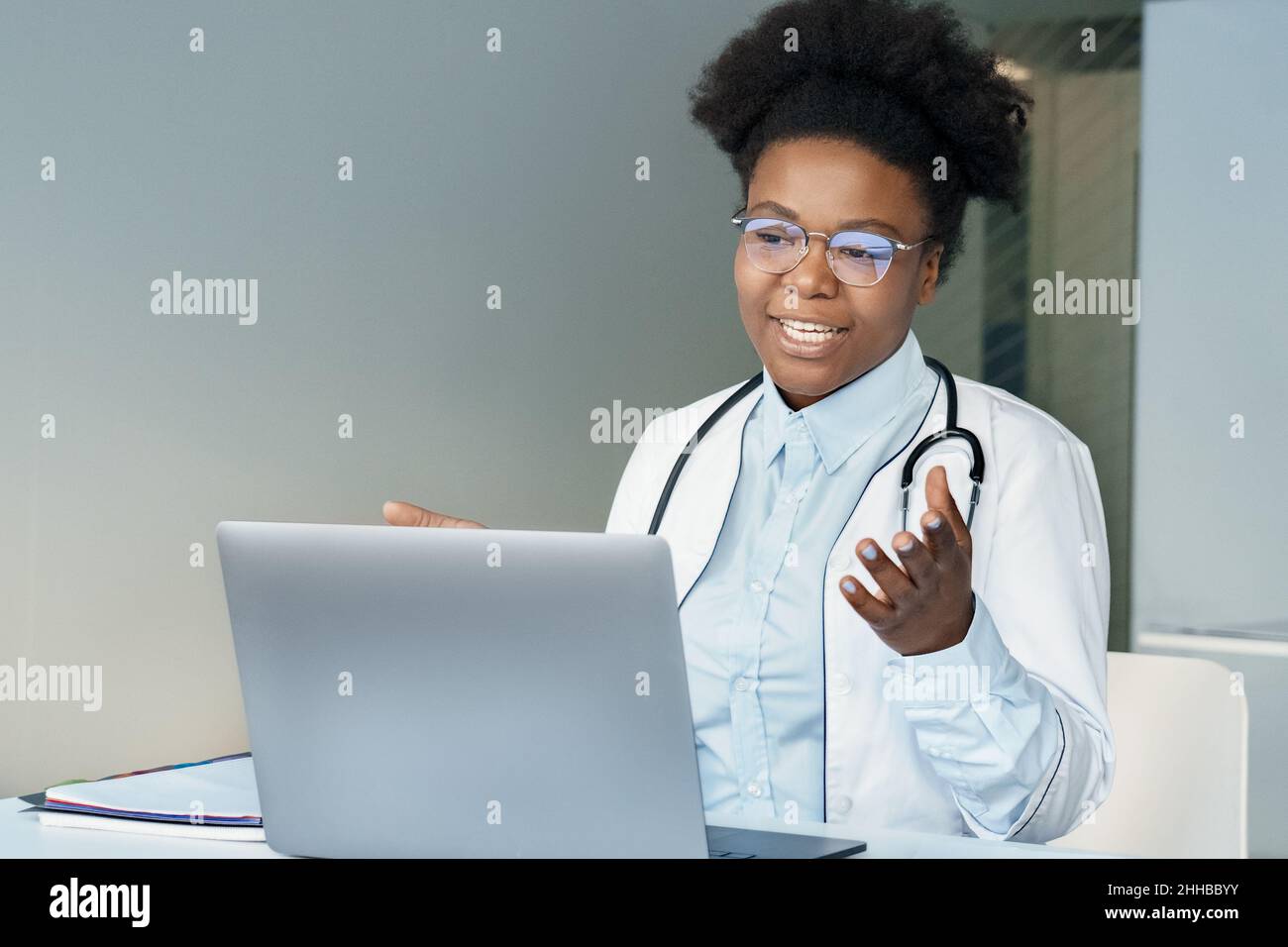African american young female doctor consulting patient online using laptop Stock Photo