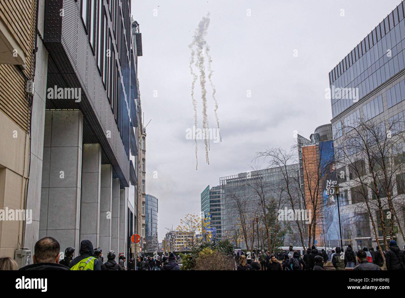 Brussels, Belgium. 23rd Jan, 2022. Police officers throw tear gas canisters at the protesters in front of Le Berlaymont during the demonstration. Thousands of people demonstrate against the mandatory vaccination, the QR pass and the Covid-19 Measures in Brussels. Police arrested demonstrators and used tear gas and water cannon after clashes erupt in the Belgian capital with damages of buildings and vehicles. Credit: SOPA Images Limited/Alamy Live News Stock Photo