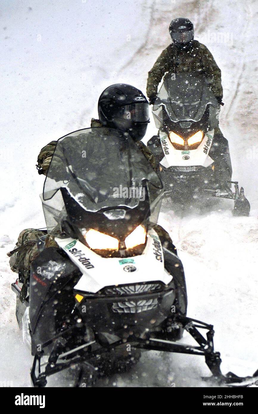 GRAYLING, Mich. – U.S. Army Soldiers from the 20th Special Forces Group, Massachusetts National Guard, conduct snowmobile training through northern Michigan’s rough terrain during Northern Strike 22-1 on Jan. 22, 2022. “Winter Strike” is held annually in northern Michigan during the coldest part of the year. Snow, high winds, and single-digit temperatures are commonplace at the National All-Domain Warfighting Center this time of year. Visiting units are able to train in subarctic conditions, so they are better able to meet the objectives laid out in the Department of Defense’s Arctic strategy. Stock Photo