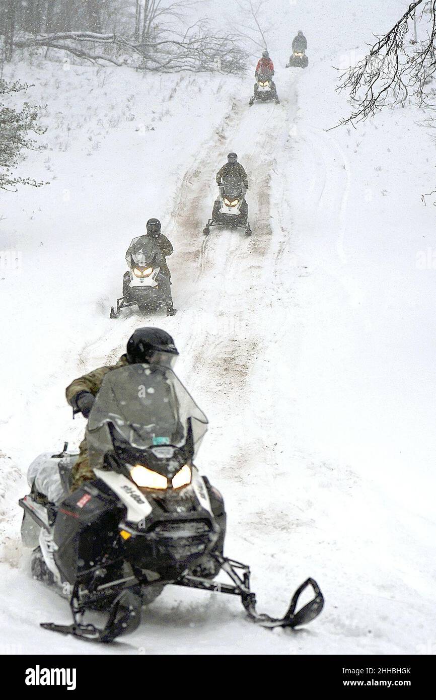 GRAYLING, Mich. – U.S. Army Soldiers from the 20th Special Forces Group, Massachusetts National Guard, conduct snowmobile training through northern Michigan’s rough terrain during Northern Strike 22-1 on Jan. 22, 2022. “Winter Strike” is held annually in northern Michigan during the coldest part of the year. Snow, high winds, and single-digit temperatures are commonplace at the National All-Domain Warfighting Center this time of year. Visiting units are able to train in subarctic conditions, so they are better able to meet the objectives laid out in the Department of Defense’s Arctic strategy. Stock Photo