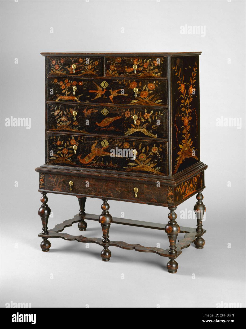 High chest of drawers 1710–25 American The decoration on this chest, with its motifs and palette of red, orange, and what was originally bright yellow on a black ground, was meant to imitate a technique known as japanning. Beginning in the mid-seventeenth century, imported Japanese and Chinese lacquer cabinets and screens became extremely popular in England. This lacquer work was much imitated in London on furniture and wall paneling. The technique eventually spread to Boston by about 1700.. High chest of drawers  4281 Stock Photo