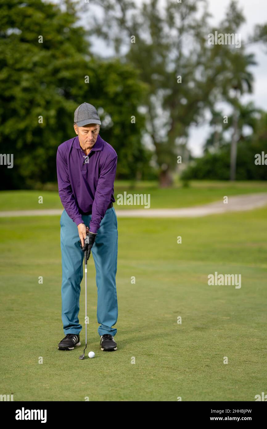 Golf guy about to make his final shot Stock Photo