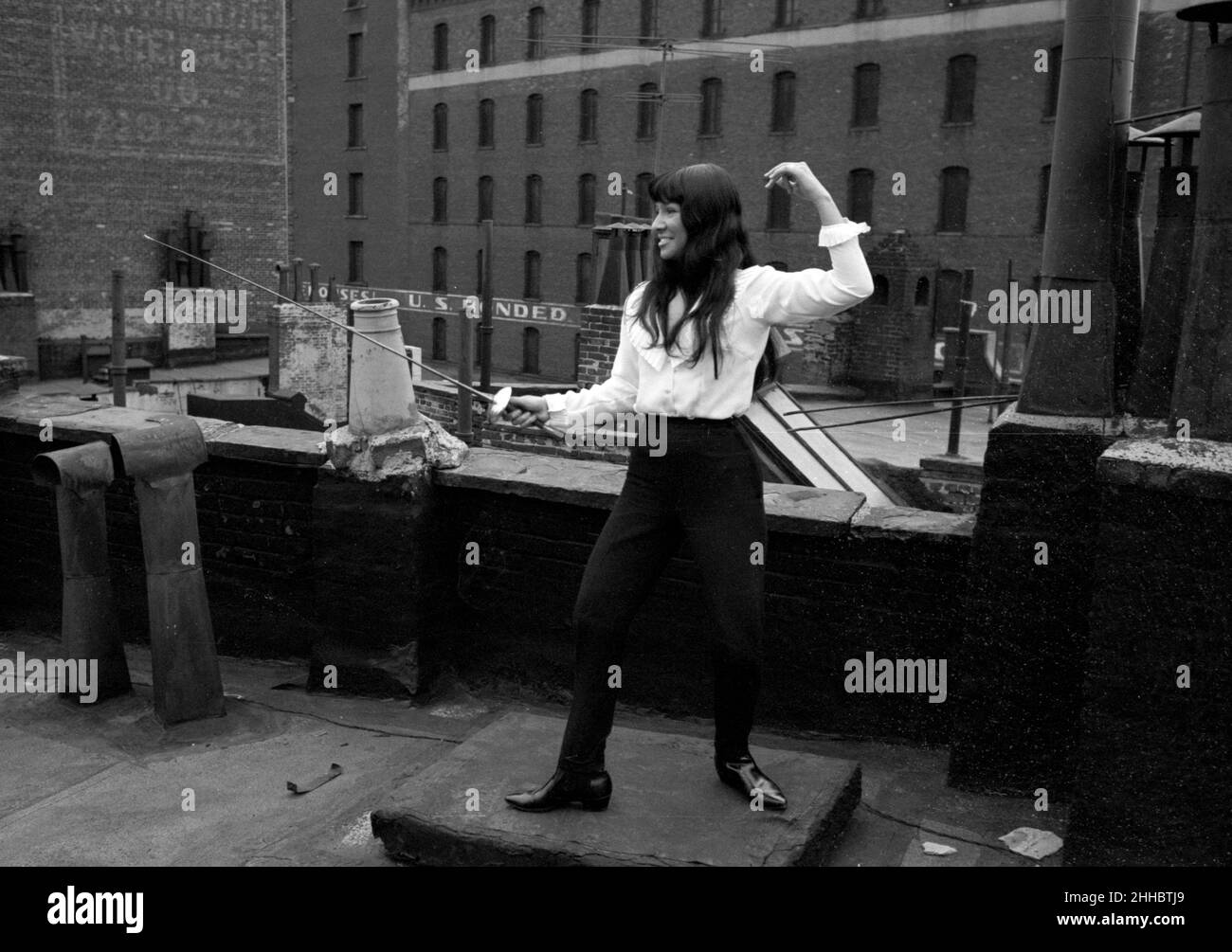 Buffy Sainte-Marie on a rooftop in NYC, with a fencing sword,1964 Stock Photo