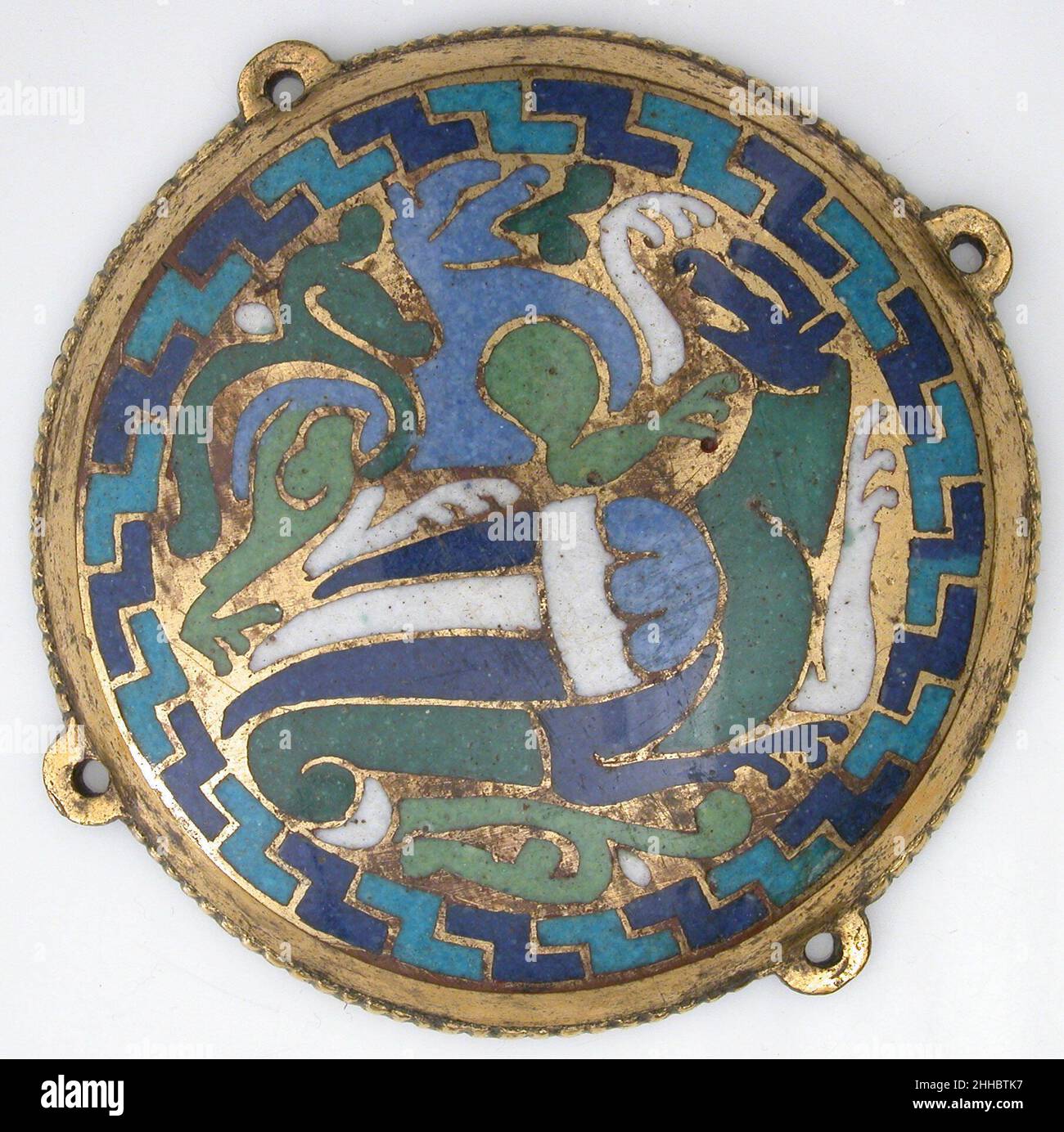 Combat Between Dragon and Dog (one of five medallions from a coffret) ca. 1110–30 French The blue and green beasts, locked in battle and compressed into these circular medallions, are emblematic of goldsmiths’ work created at Conques under the patronage of Abbot Boniface (r. 1107–after 1121). On a similar box still at Conques, an inscription proudly proclaims: “In all respects, the coffrets of Conques demonstrate brilliant workmanship.”. Combat Between Dragon and Dog (one of five medallions from a coffret)  464564 Stock Photo