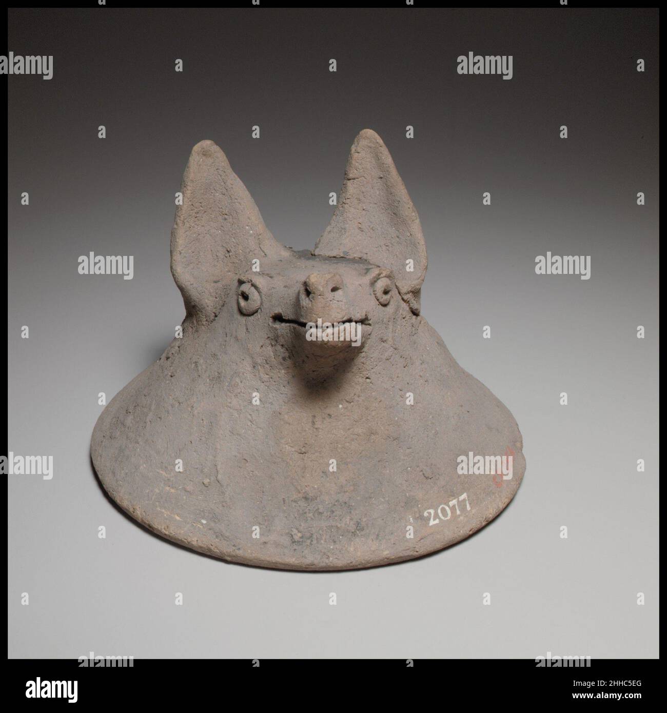 Terracotta mask in the shape of the head of a fox, dog, or bat ca. 600–480 B.C. Cypriot The mask is handmade. It has a flaring, bell-shaped neck and pellet eyes.. Terracotta mask in the shape of the head of a fox, dog, or bat  241316 Stock Photo