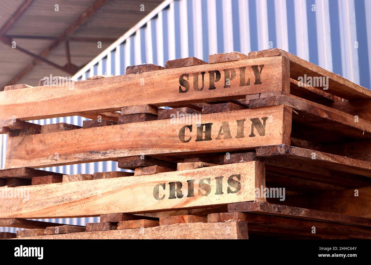 'Supply Chain Crisis', text written on piled up pallets. Supply chain concept. Logistics concept. Coronavirus (COVID-19) effect. Stock Photo
