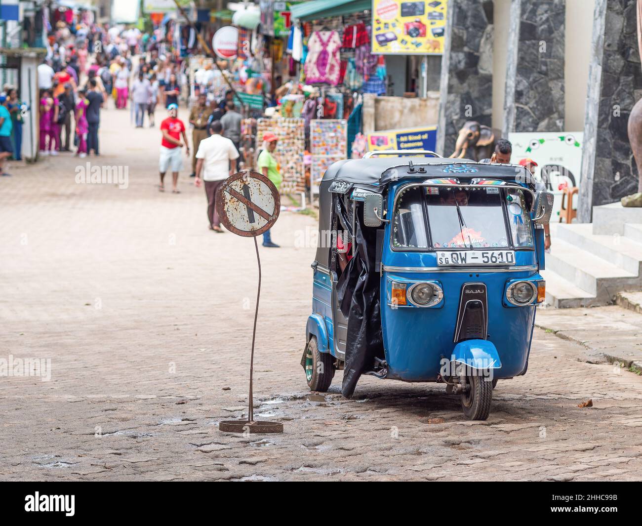 Auto rickshaw, also called tuk-tuk, at shopping street in Pinnawala, Rambukkana Province, Sri lanka. Stock Photo