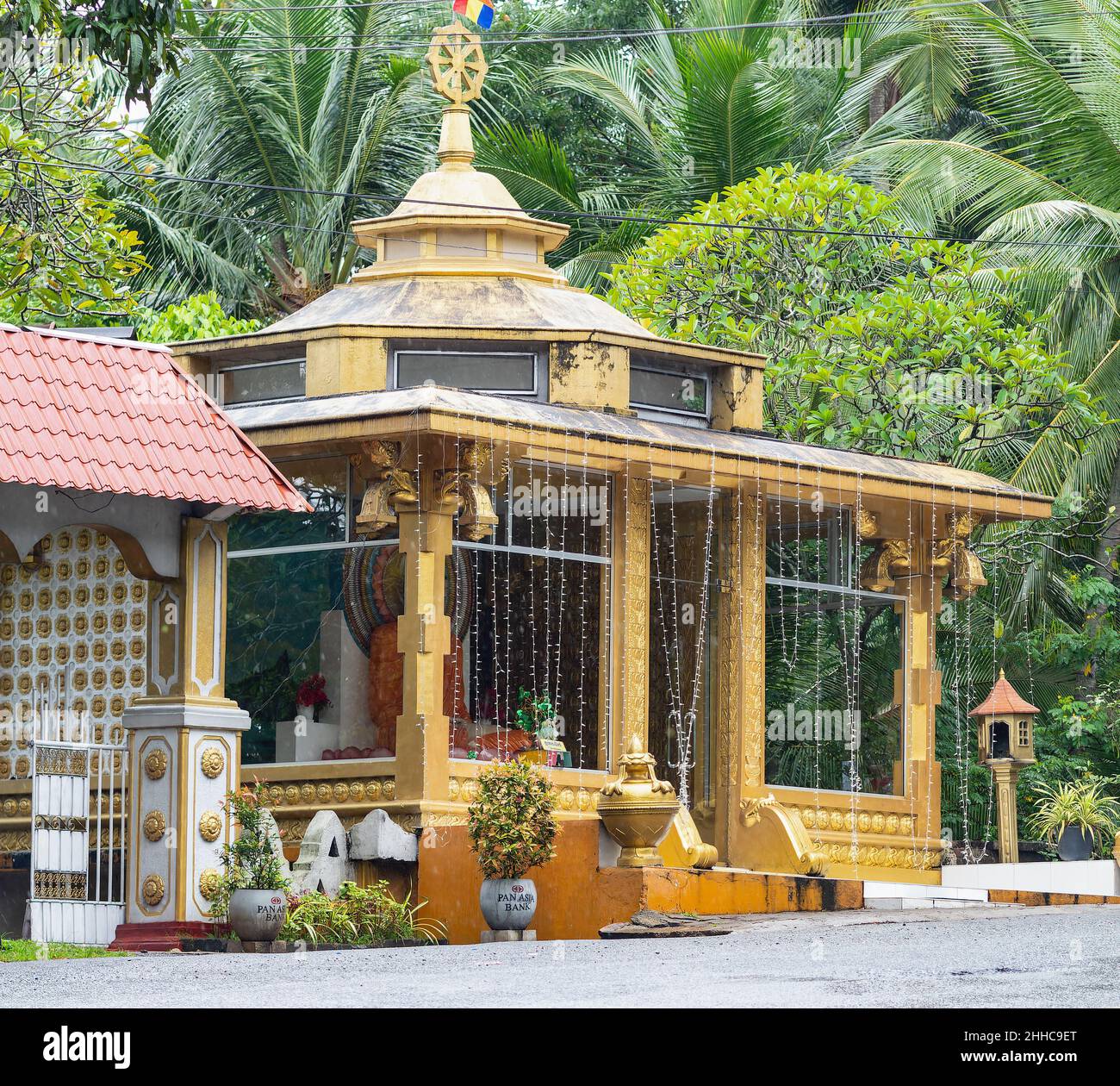 Roadside Buddhist shrine near Kandy in Sri Lanka. Stock Photo
