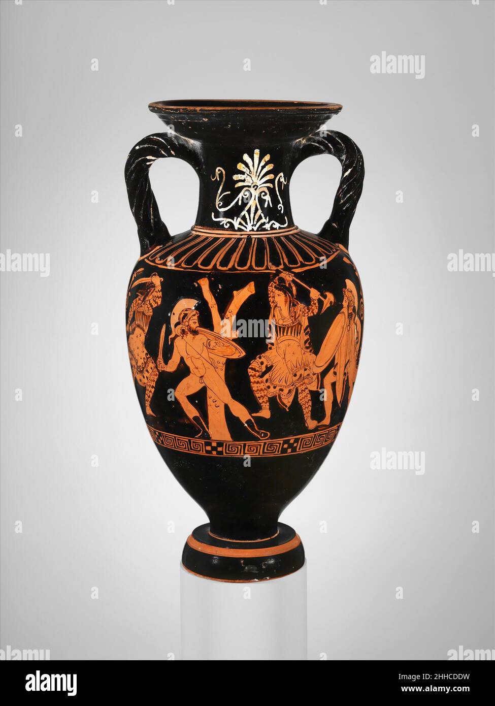 Terracotta neck-amphora (jar) with twisted handles ca. 400 B.C. Attributed to the Suessula Painter Obverse, combat of Greeks against AmazonsReverse, three youthsThis vase is complementary in its main scene to the adjacent work with which it was found. The battle scene reveals the artist's interest in action and his ease with the medium. It is particularly revealing to contrast the conventional, rather anemic palmette on the neck with the barren tree that the artist had seen first-hand.. Terracotta neck-amphora (jar) with twisted handles  254518 : Attributed to the Suessula Painter, Terracotta Stock Photo