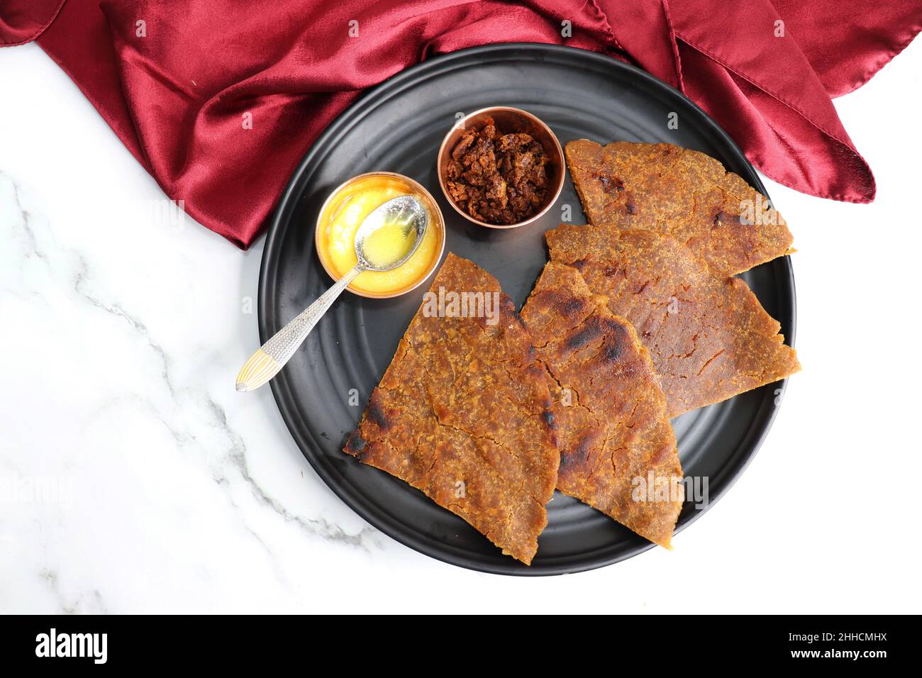 Sweet roti made out of rice flour, jaggery, and ghee. Gud ki roti. gur