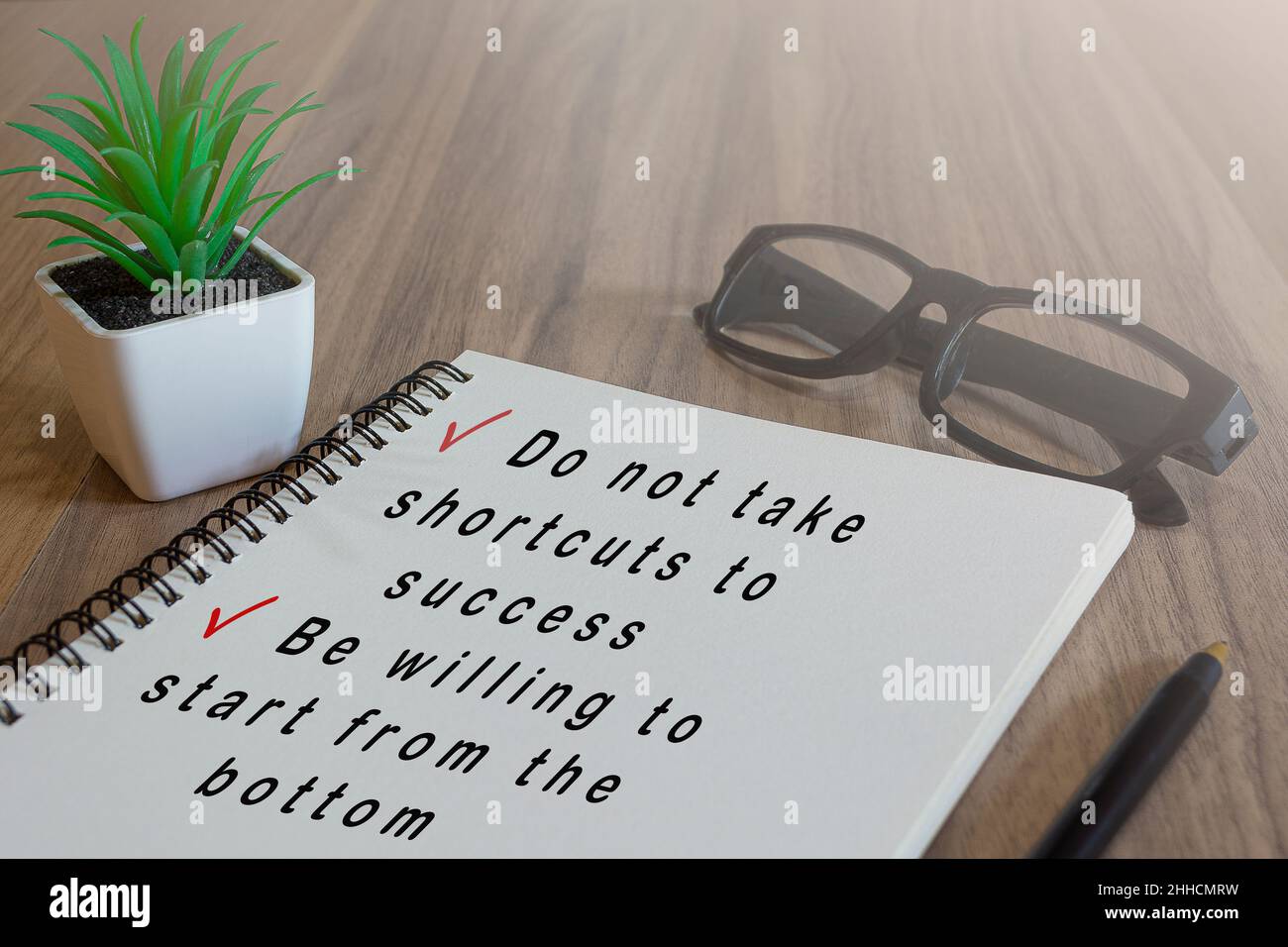 Text on white notepad on wooden desk. Success concept Stock Photo
