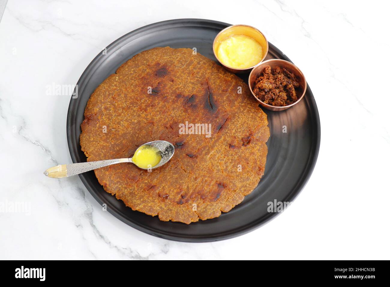 Sweet roti made out of rice flour, jaggery, and ghee. Gud ki roti. gur