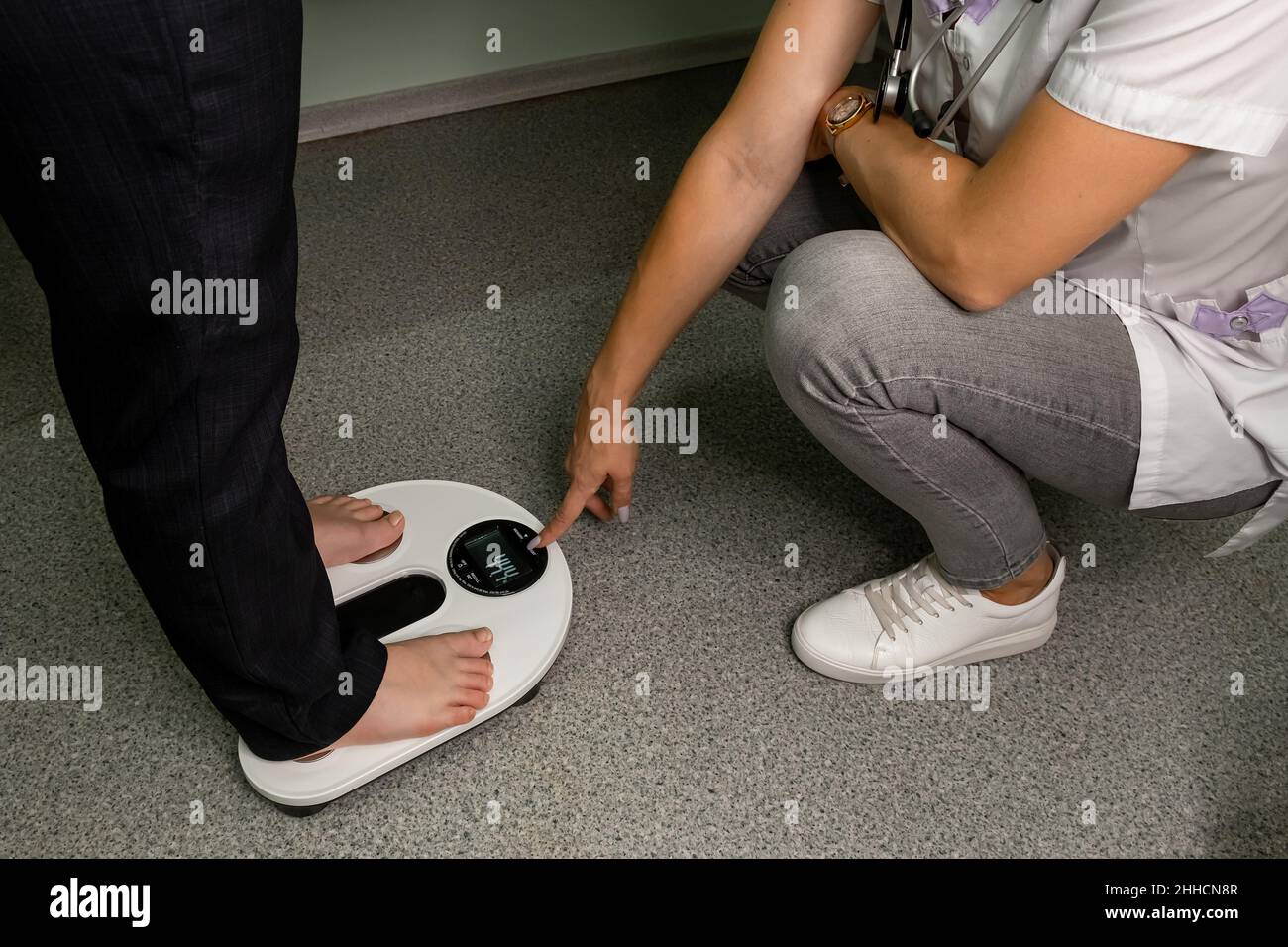 Woman checking body with composition analysis machine. Stock Photo