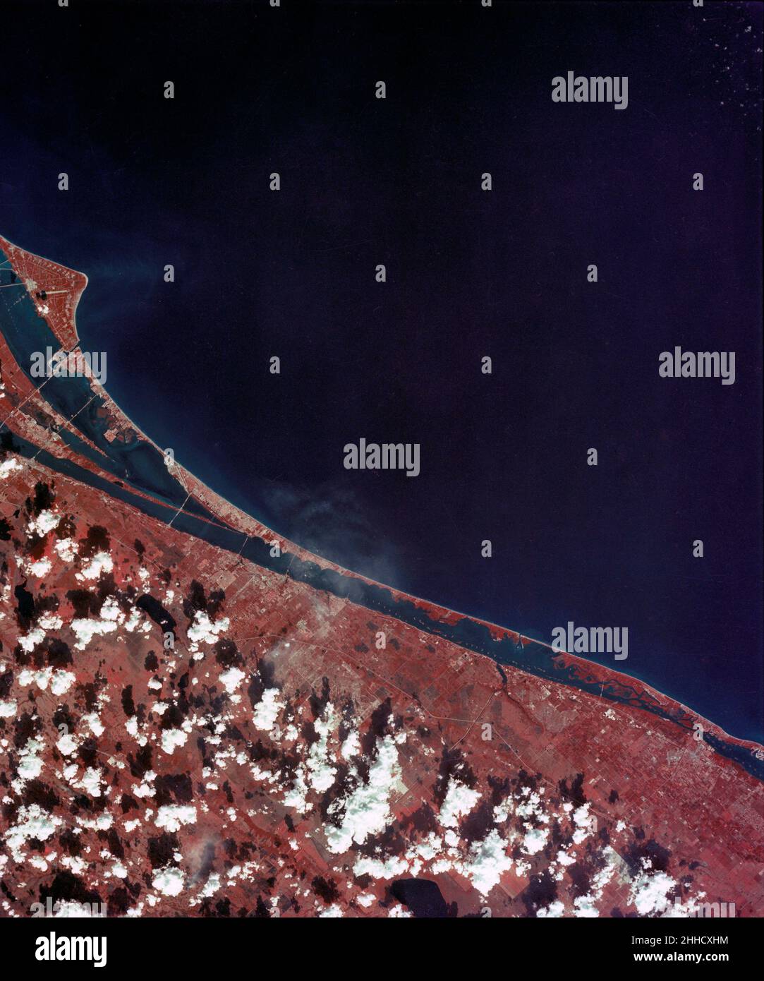 (February 1974) --- A vertical view of the Kennedy Space Center and the Florida Atlantic coast area is seen in this Skylab 4 Earth Resources Experiments Package S190-B (five-inch earth terrain camera) infrared photography taken from the Skylab space station in Earth orbit. This photograph shows the major land-ocean features of the Florida coast near Vero Beach northward to Cape Canaveral and the KSC complex. The launch pads for the Skylab missions are clearly visible. Identification of living vegetation is possible through the use of the color infrared film. Various shades of red portray diffe Stock Photo