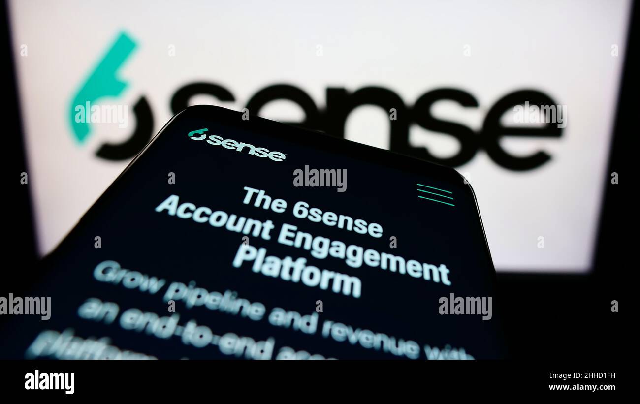 Smartphone with webpage of American software company 6Sense Insights Inc. on screen in front of business logo. Focus on top-left of phone display. Stock Photo