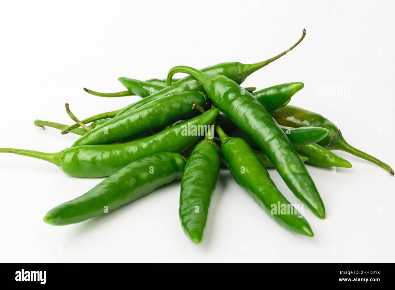 Green chilli on white background Stock Photo - Alamy