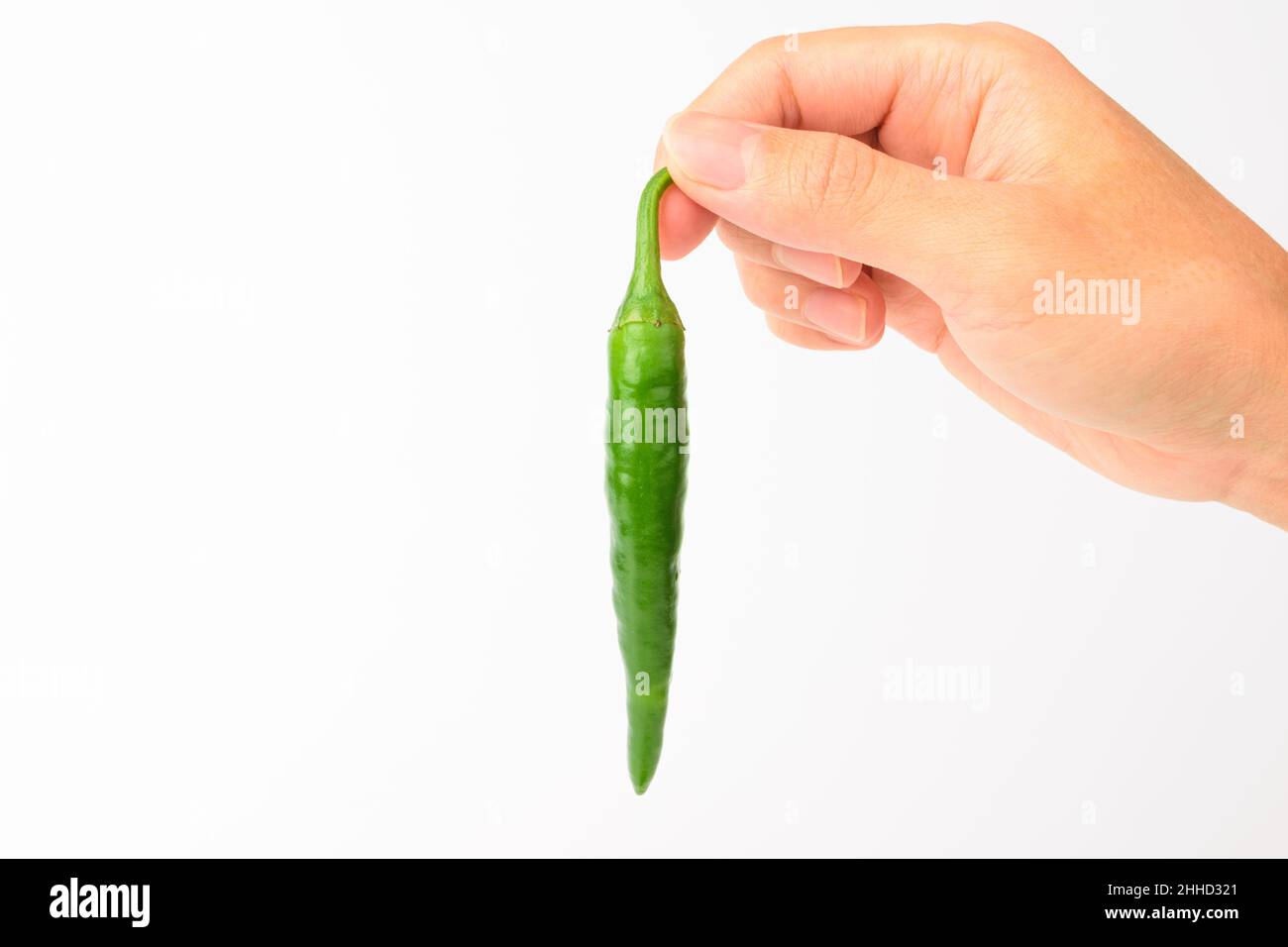 Green chilli on white background Stock Photo - Alamy