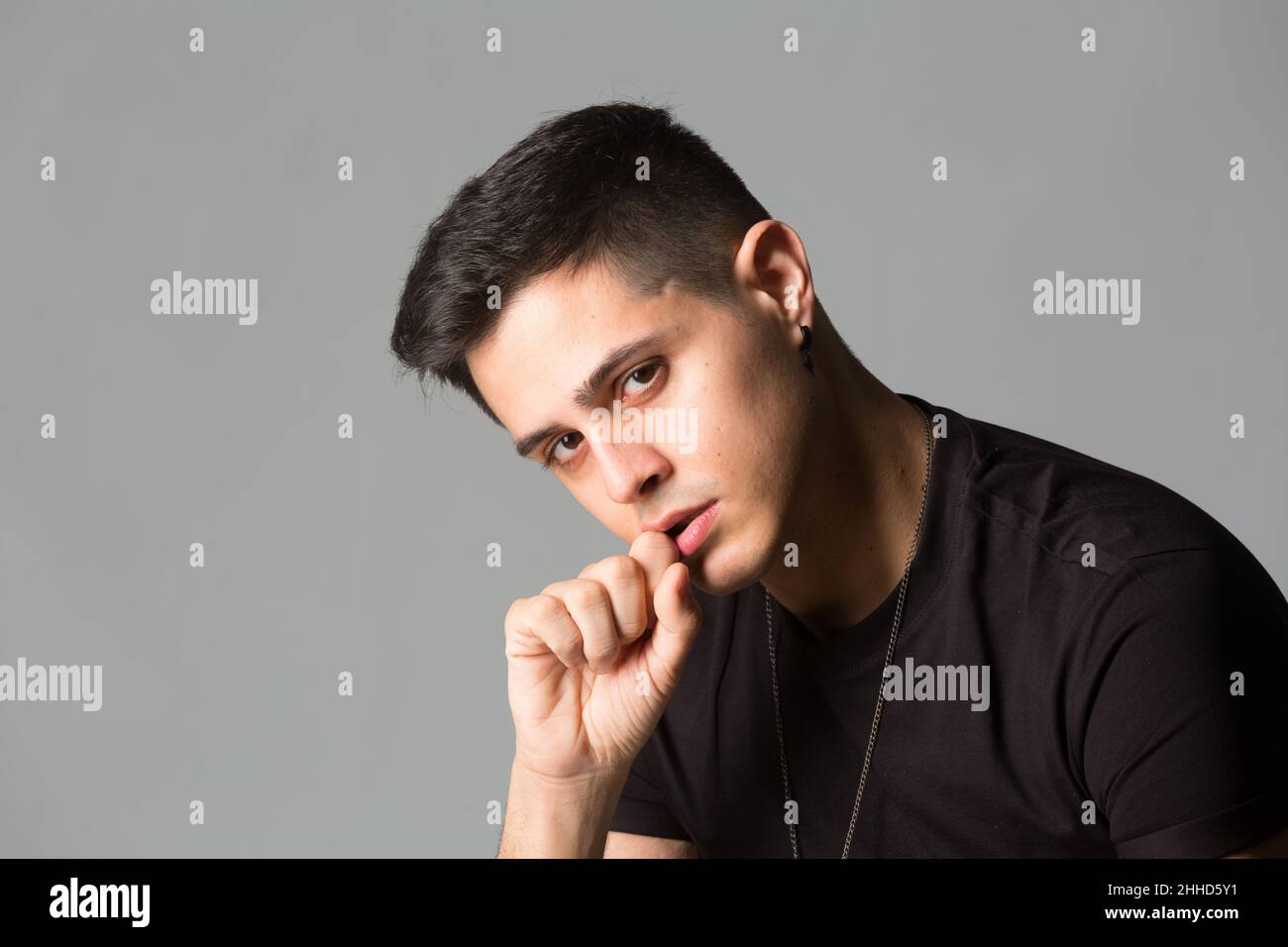 Thoughtful young man with his hands on his head Stock Photo