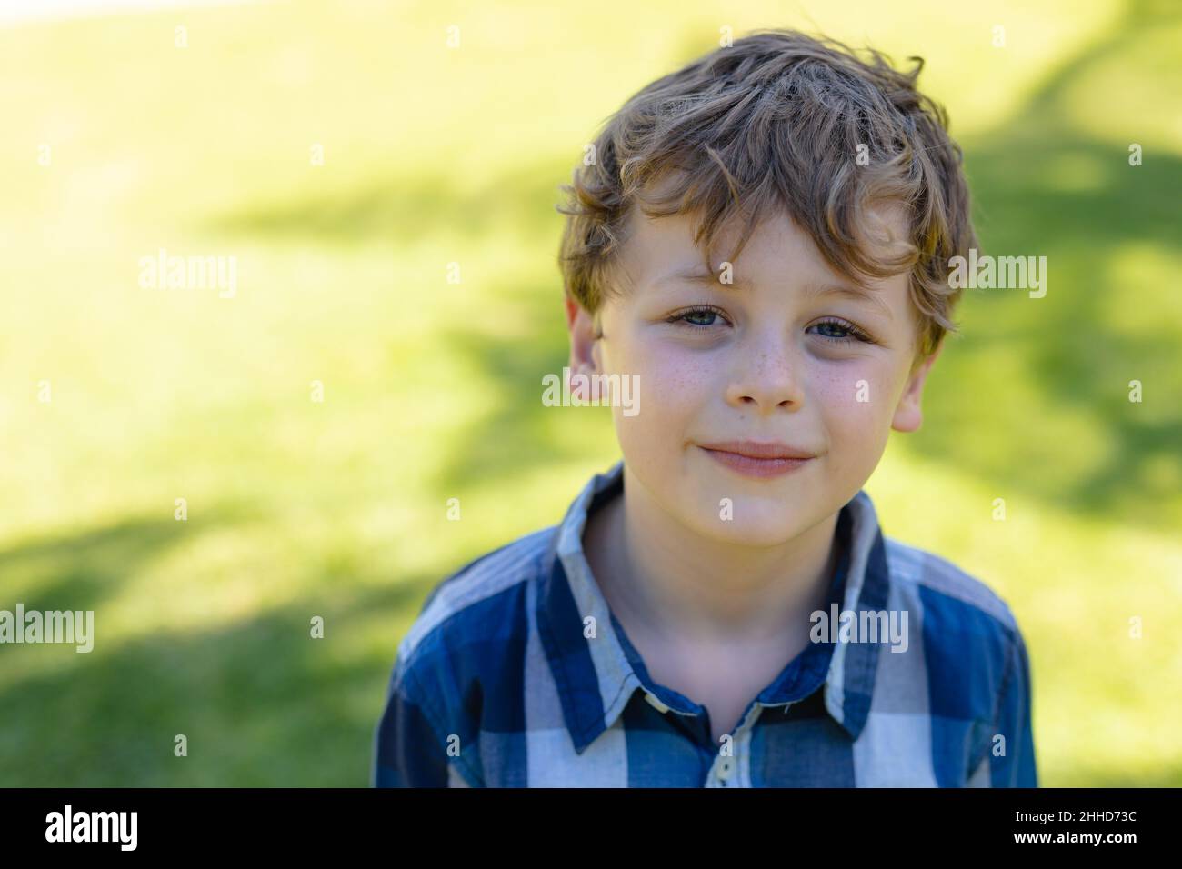 Portrait of caucasian boy smiling while standing in the garden Stock Photo