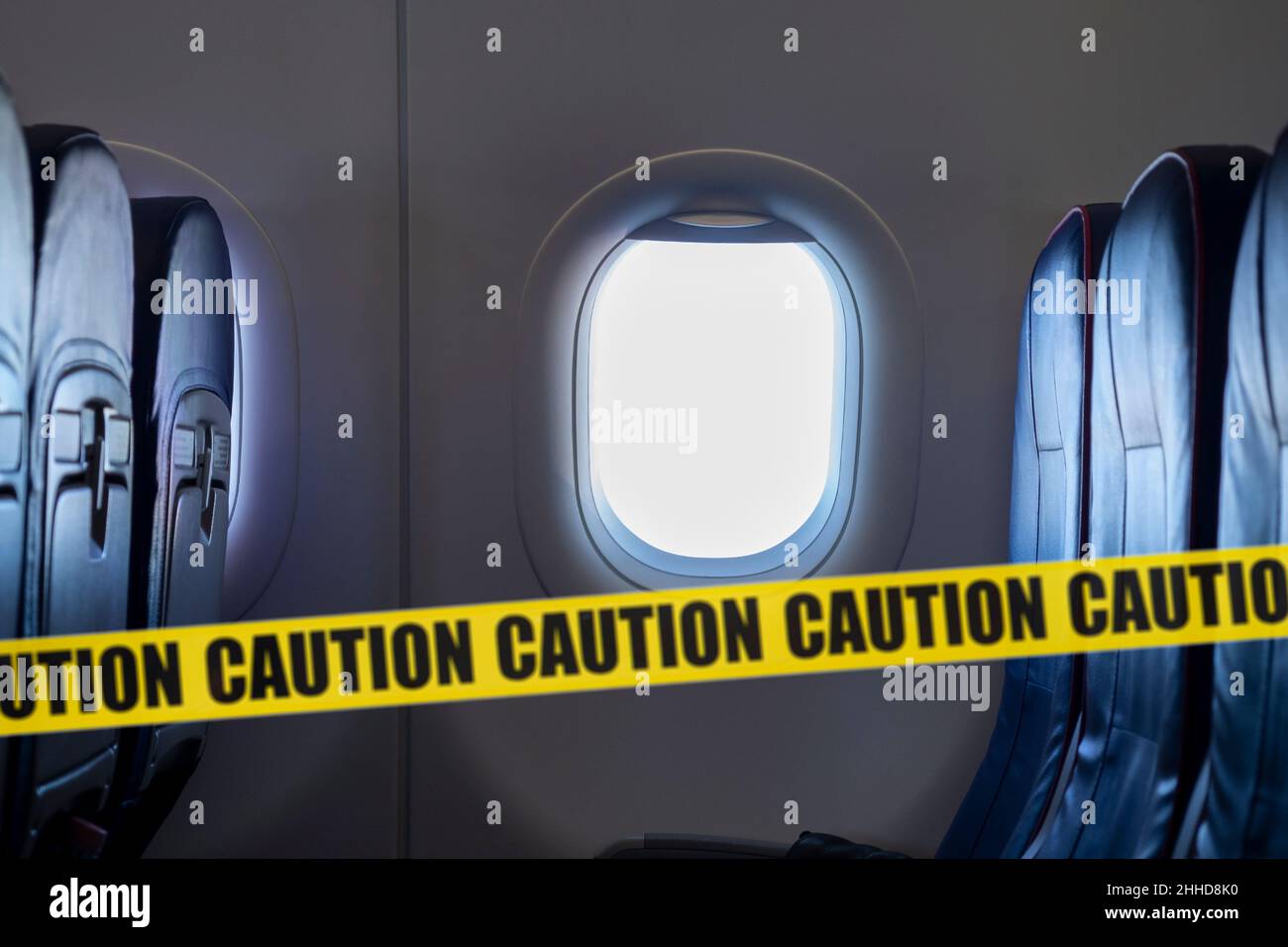Empty interior of an airplane and yellow tape means do not sitting here