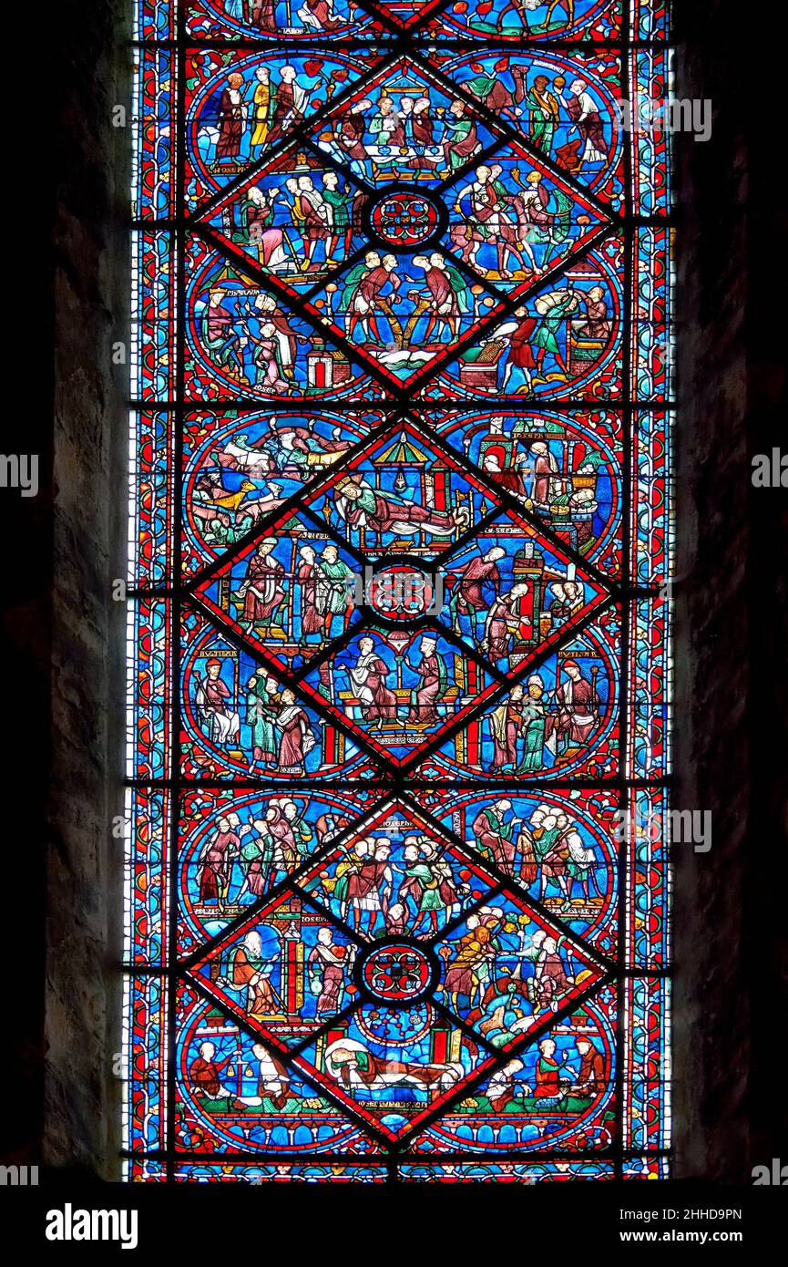 Medieval stained glass Window of the Gothic Cathedral of Chartres, France- dedicated to Joseph the Patriach . A UNESCO World Heritage Site.  The stain Stock Photo