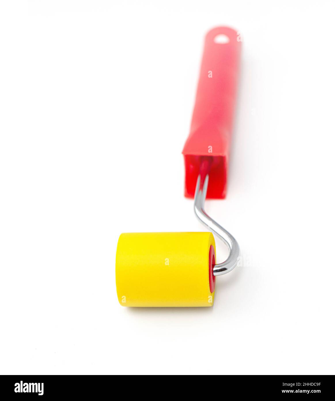 Yellow rubber paint roller on a white background Stock Photo Alamy