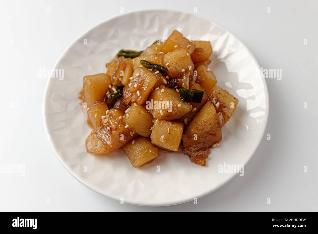 Simmered potatoes in soy sauce on a white background Stock Photo Alamy