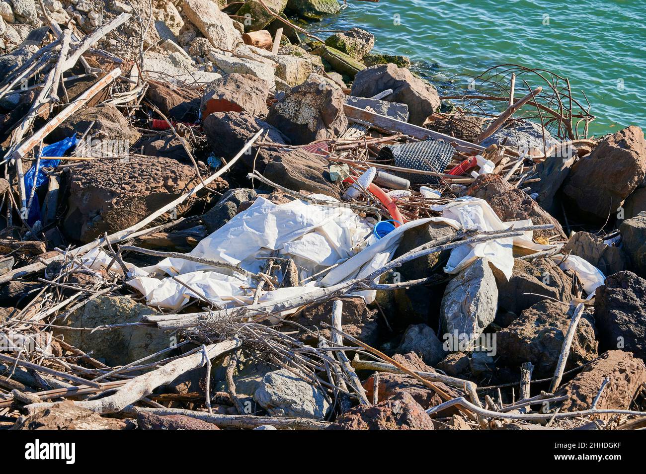 Plastic waste brought to shore by the tide Stock Photo