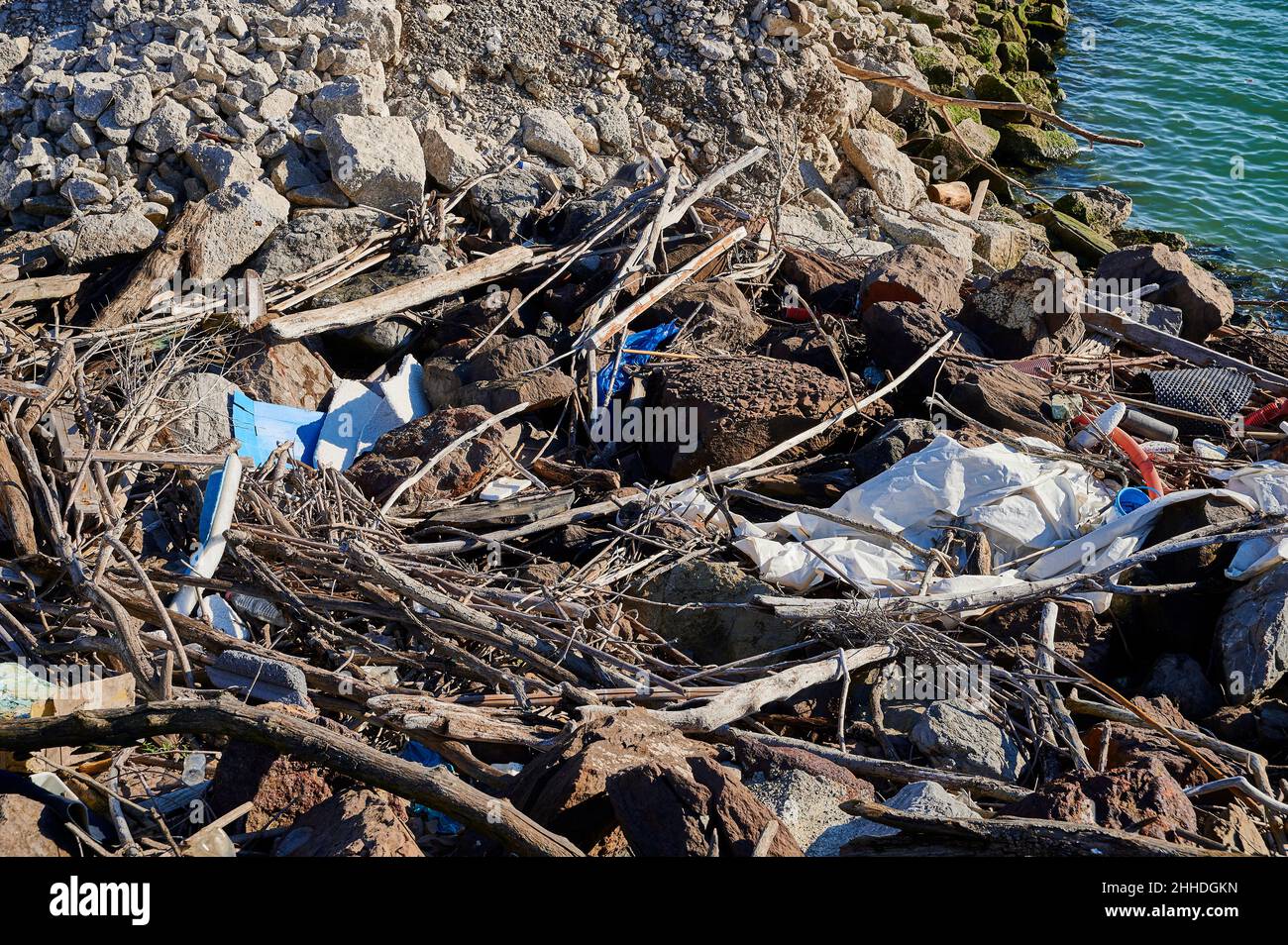 Plastic waste brought to shore by the tide Stock Photo