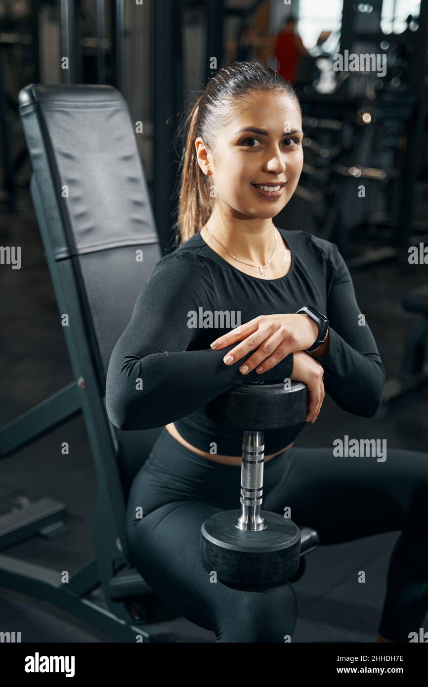 Joyous female athlete posing for camera during gym workout Stock Photo