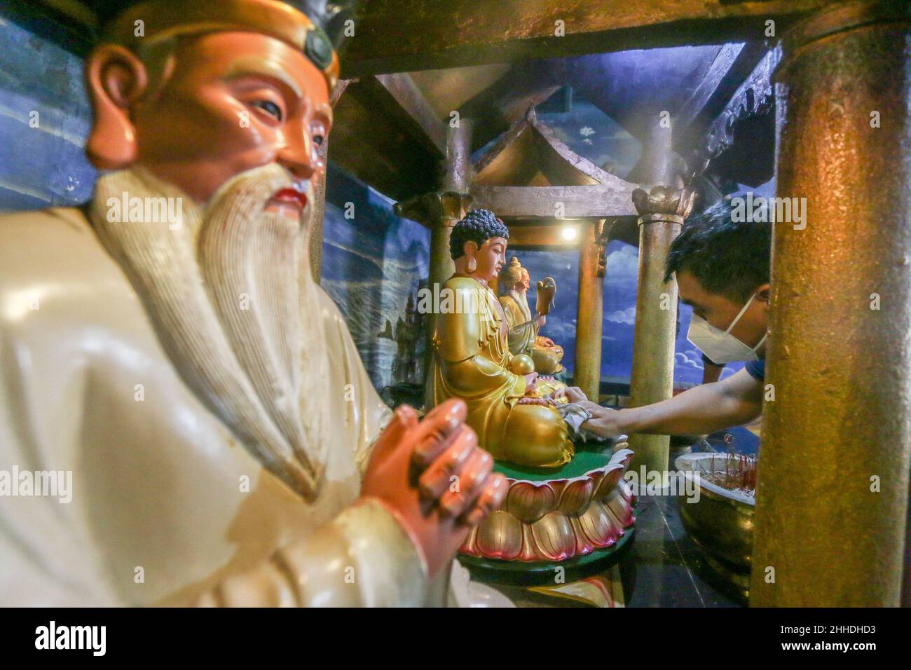 the tradition of cleaning altars and statues of gods at the Buddhist Dharma & 8 Pho Sat monastery welcoming the Chinese New Year in Bogor, Indonesia Stock Photo
