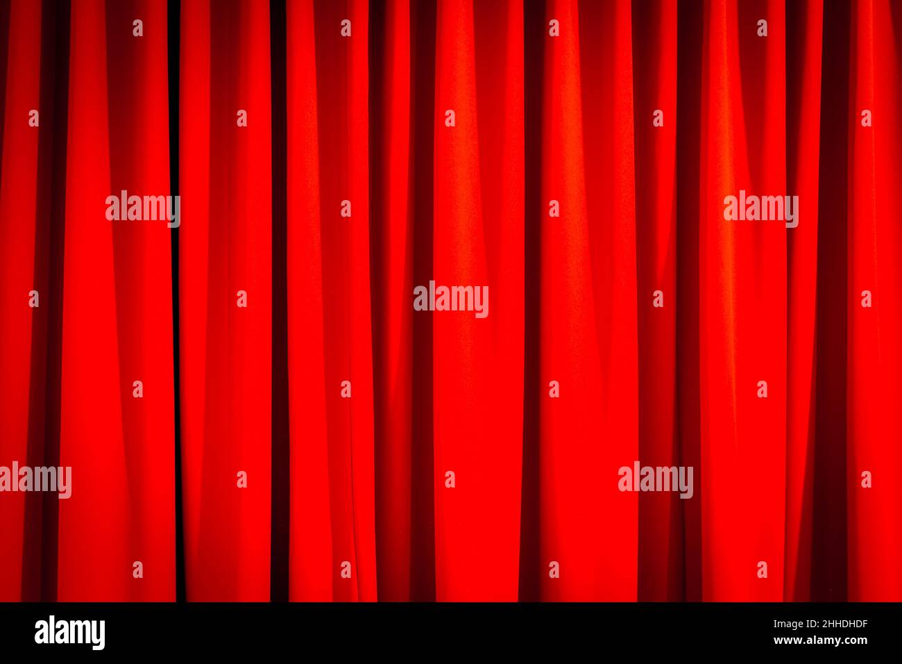 Red closed curtain with a light spot use for background Stock Photo