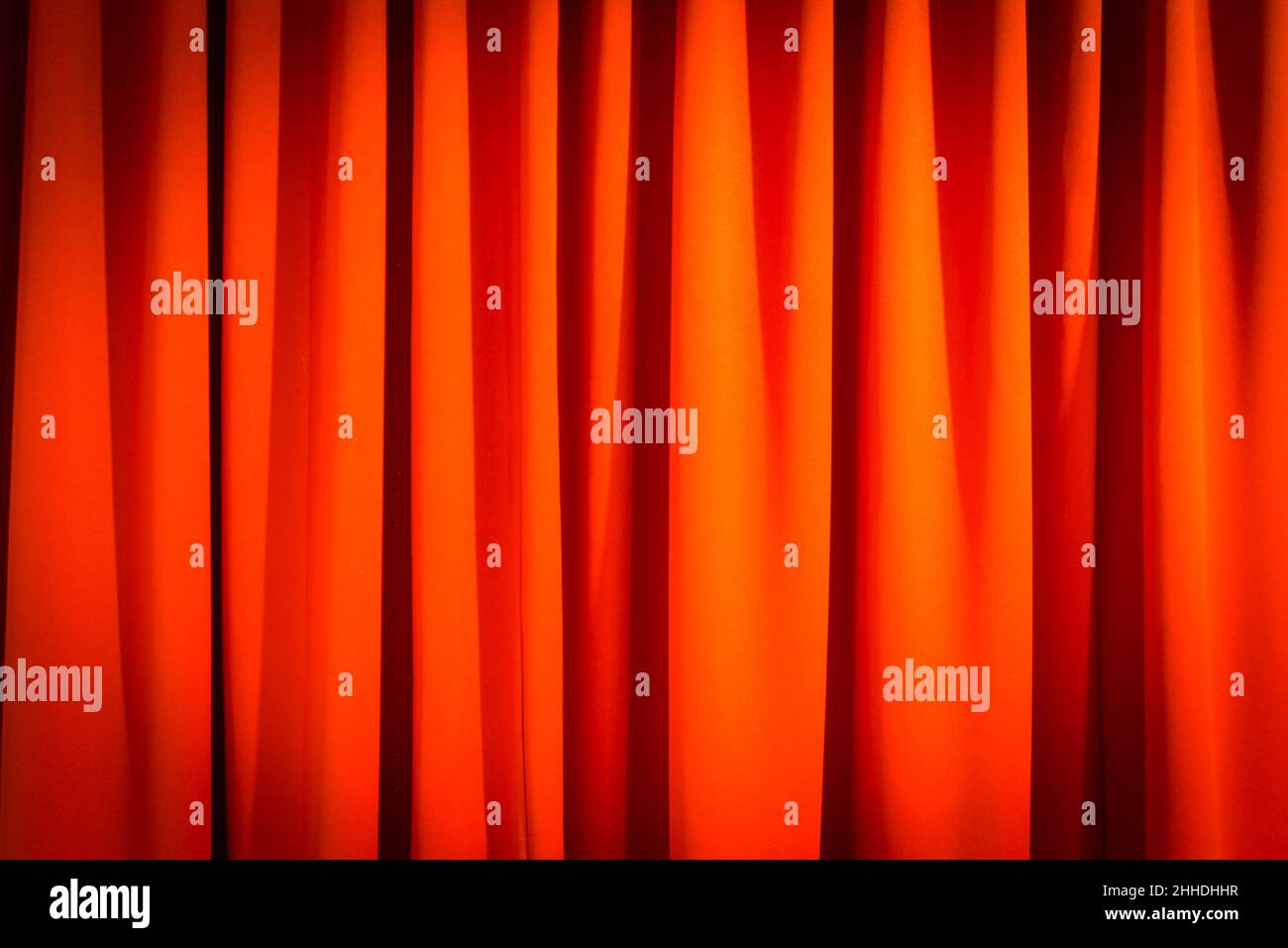 Red closed curtain with a light spot use for background Stock Photo