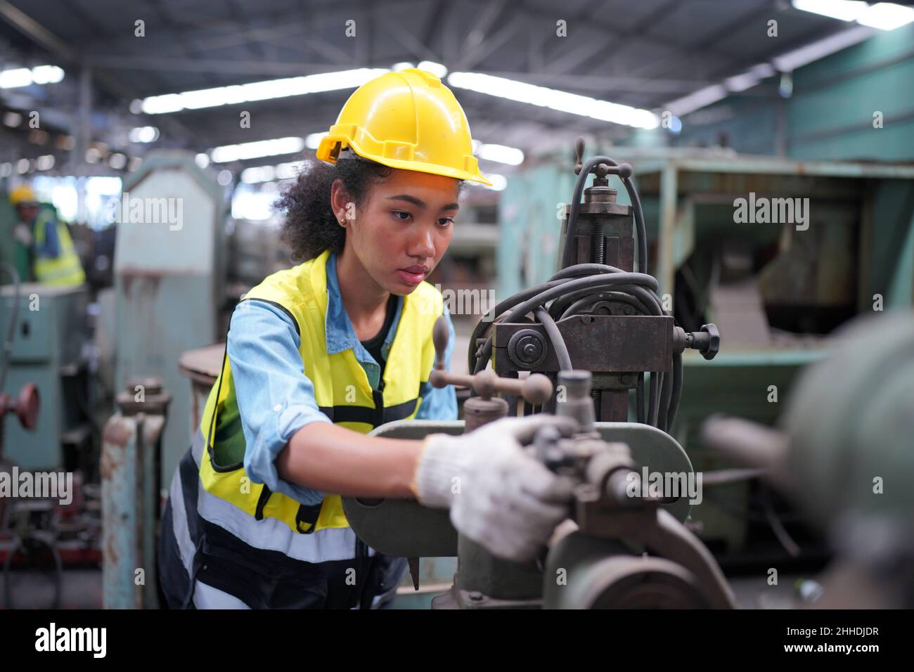 Female apprentice in metal working factory, Portrait of working female industry technical worker or engineer woman working in an industrial manufactur Stock Photo