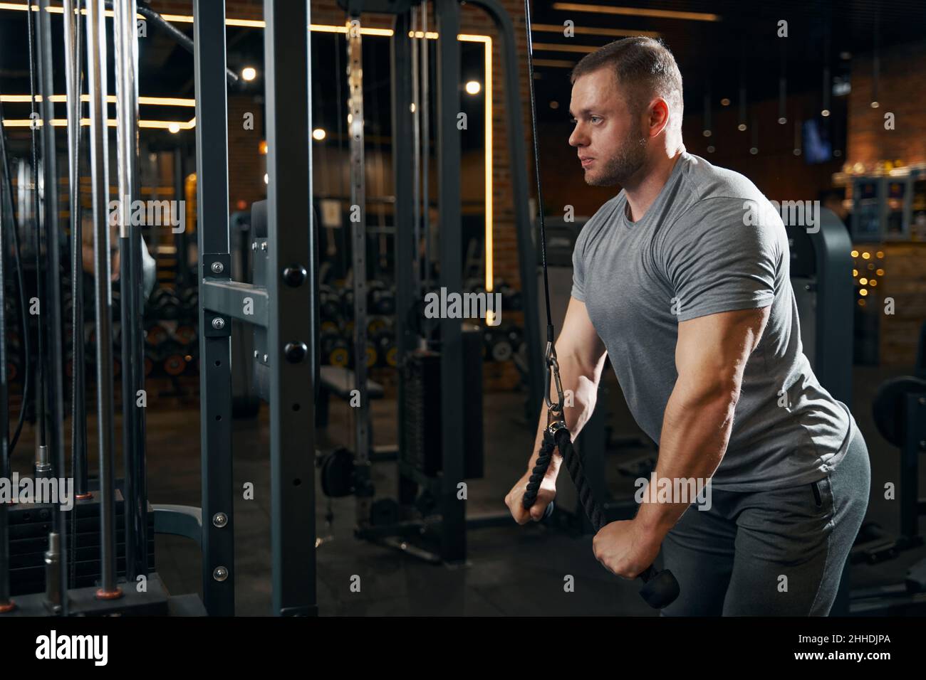 Focused athlete working out on cable machine Stock Photo