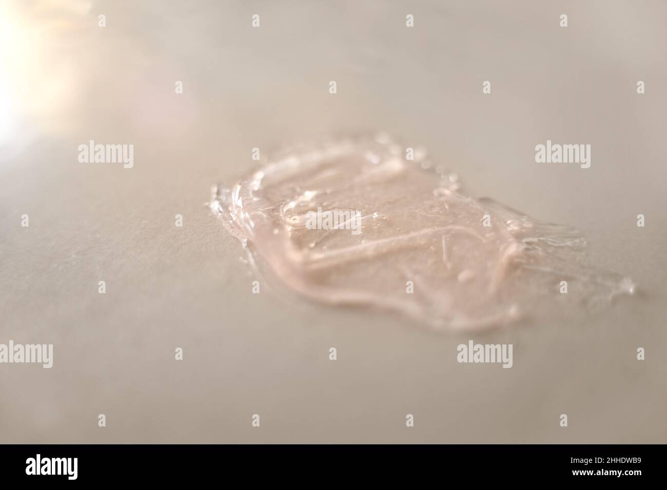 Close-up pink gel swatch smudge with air bubbles on beige background ...
