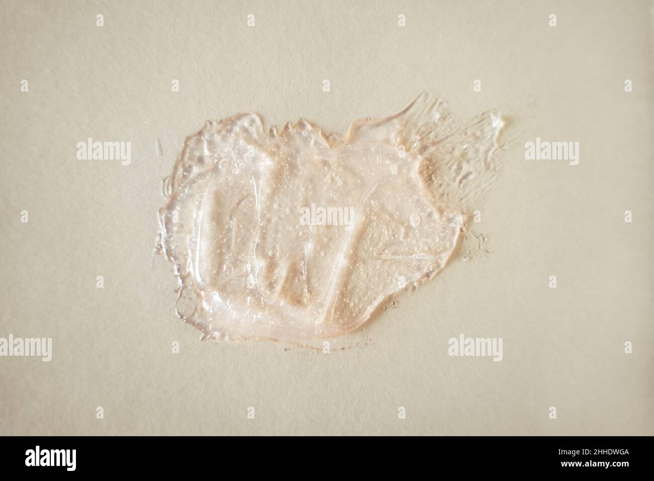 Close-up pink gel swatch smudge with air bubbles on beige background ...