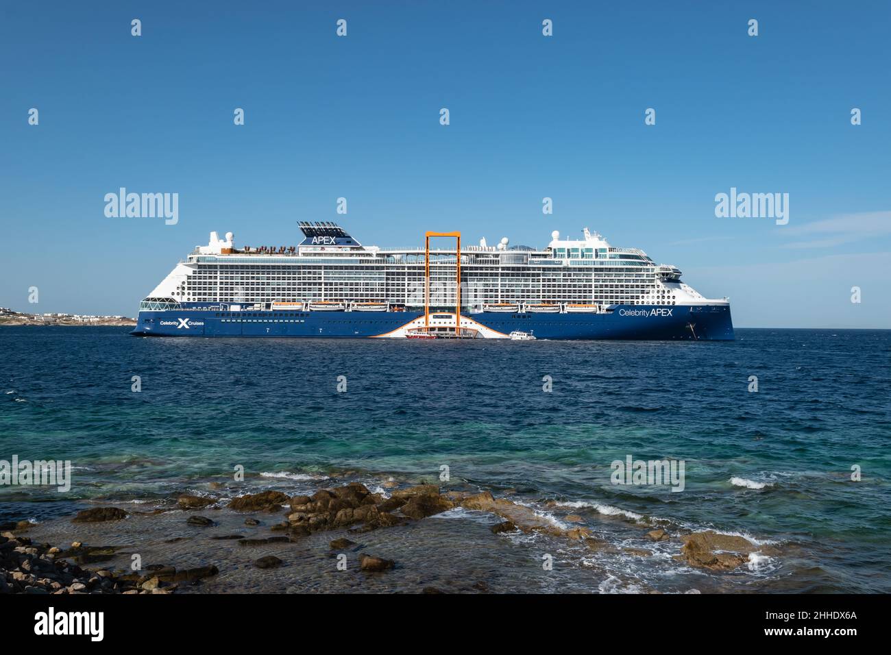 MYKONOS, GREECE - SEPTEMBER 21, 2021: Cruise ship Apex Celebrity Cruises anchored in harbor bay of Mykonos Island, Greece. Stock Photo