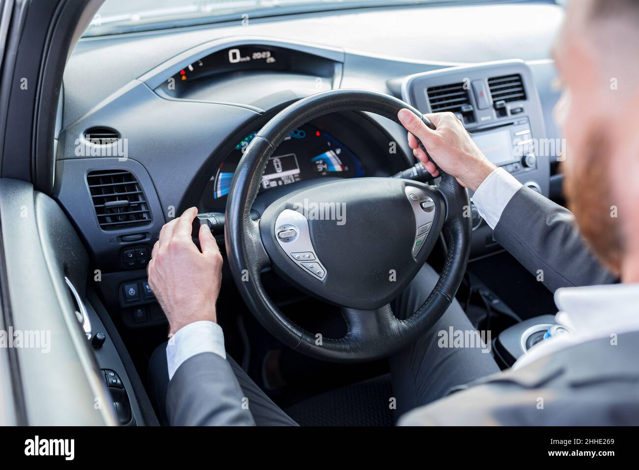 interior of the car, the man switches light modes and turns on the turn
