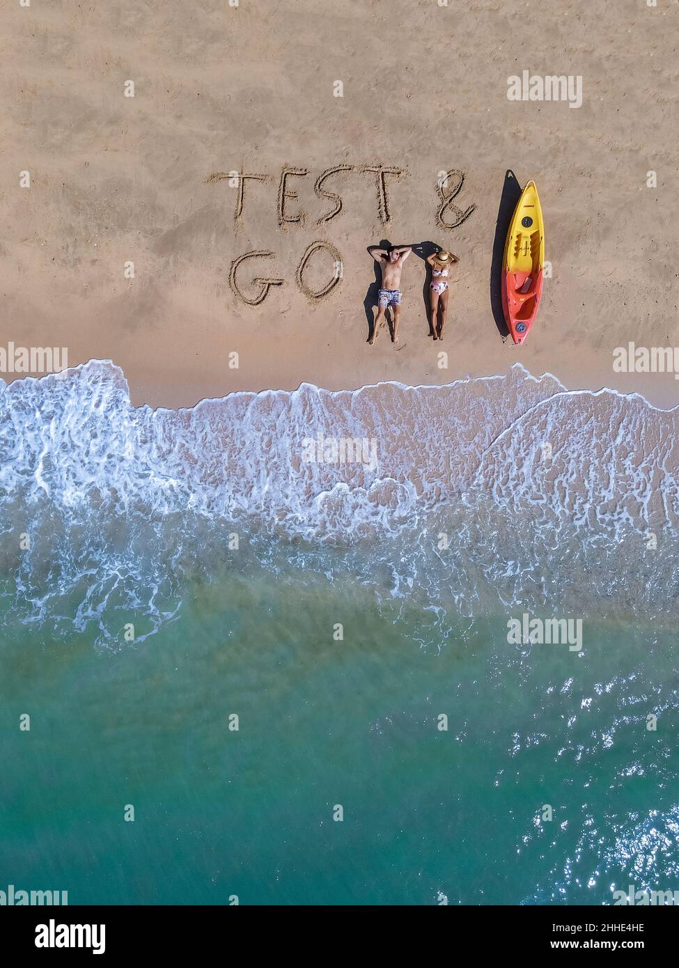 Couple on the beach with Test Go sign on the beach in Thailand Pattaya, Test and Go sign on the beach from above with a drone. man and woman on a tropical beach in Thailand Stock Photo