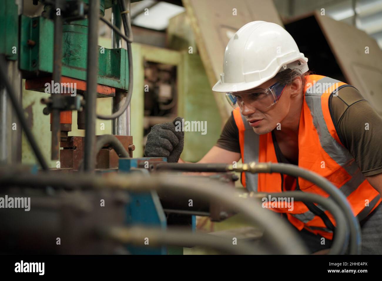 Factory Engineer Operating Hydraulic Tube machine. Men industrial