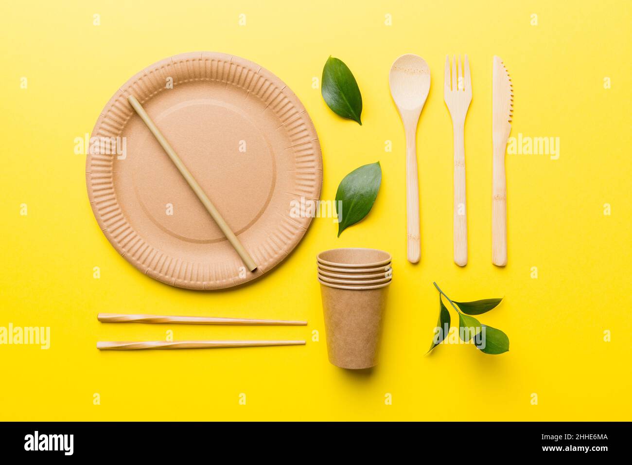 set of empty reusable disposable ecofriendly plates, cups, utensils on light white colored