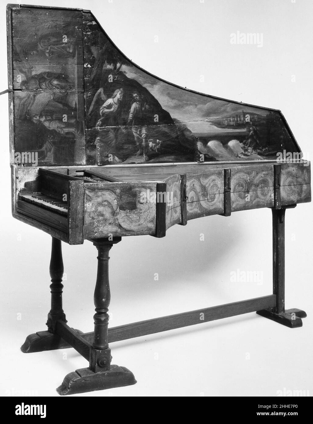 Harpsichord 16th or 17th century Italian The painting on the inside of the lid features a scene of Tobias and the Angel.Technical description: Inner-outer case construction, inner case possibly made of cedar, soundboard may be cedar (or spruce or fir), outer case of painted deal, on stand with three legs and stretchers (the rear leg is square and not turned like the other two, not original); C/E-c3, 2x8', box guides now fixed in place, at some point were movable by knobs or wires extending through the cheek (probably not original); naturals of an unidentified light brown wood (may be replaceme Stock Photo