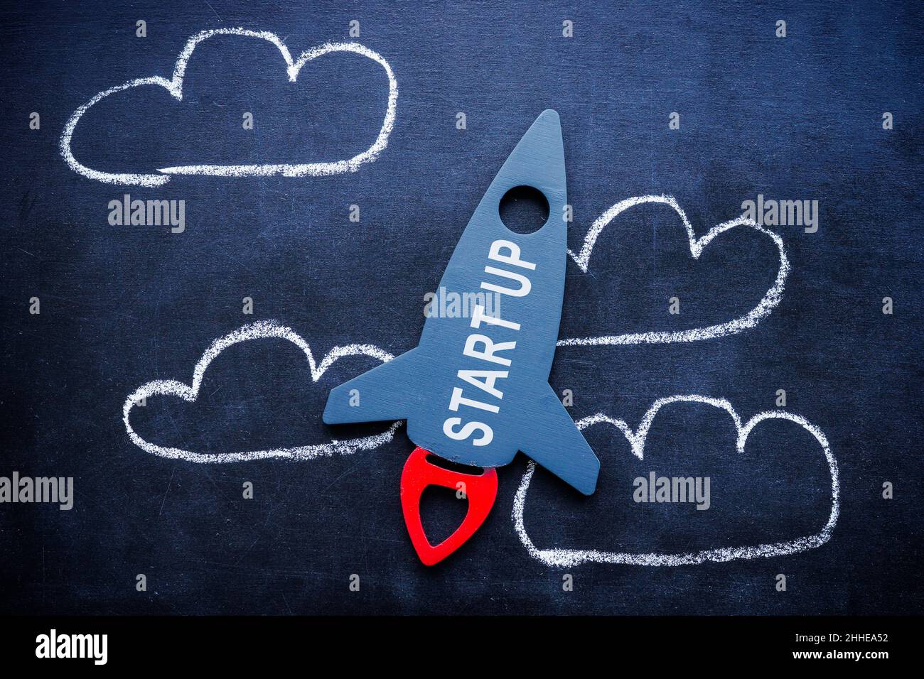Rocket with the word startup and drawn clouds. Starting a new business. Stock Photo