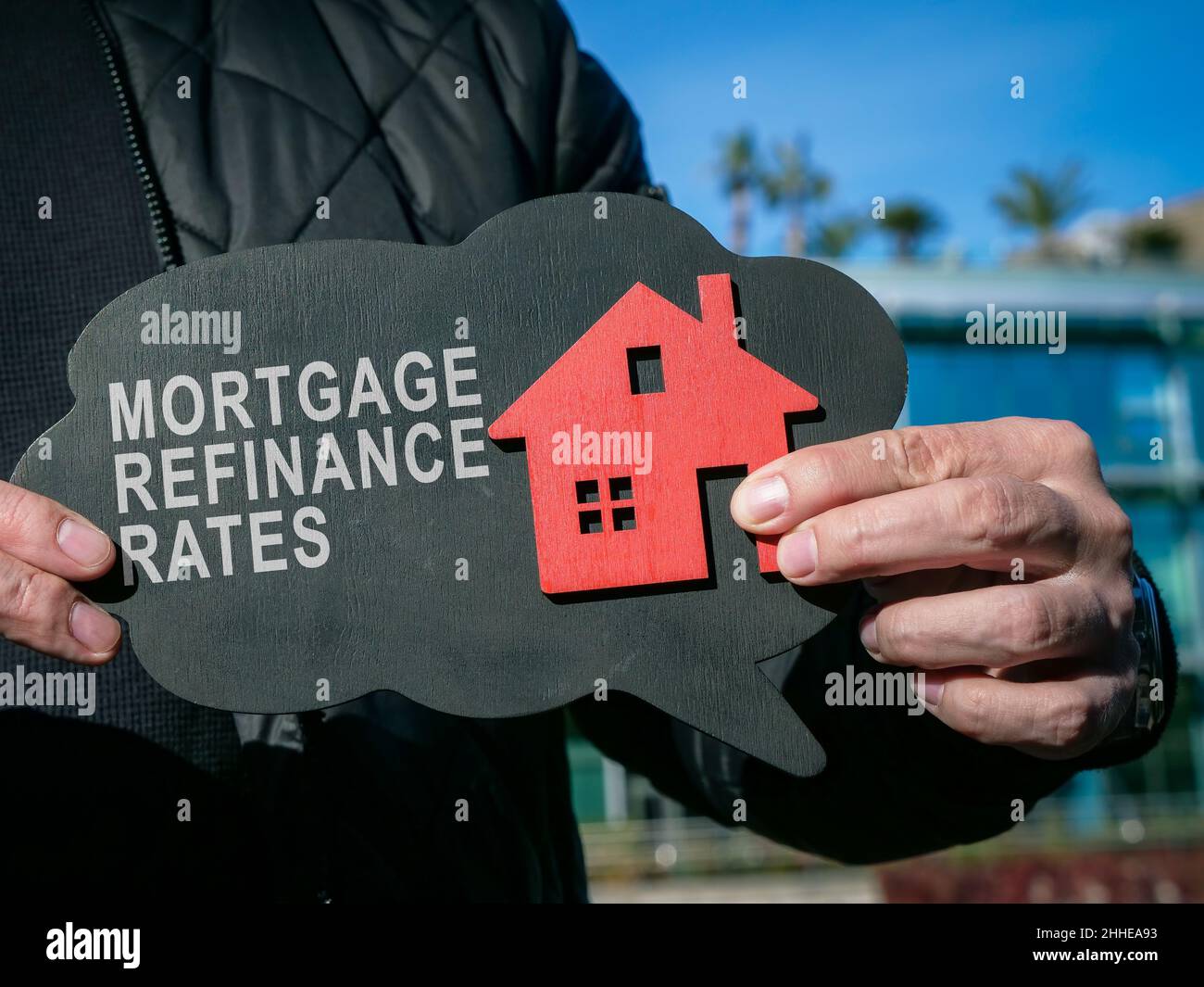 Man shows inscription Mortgage refinance rates and home. Stock Photo