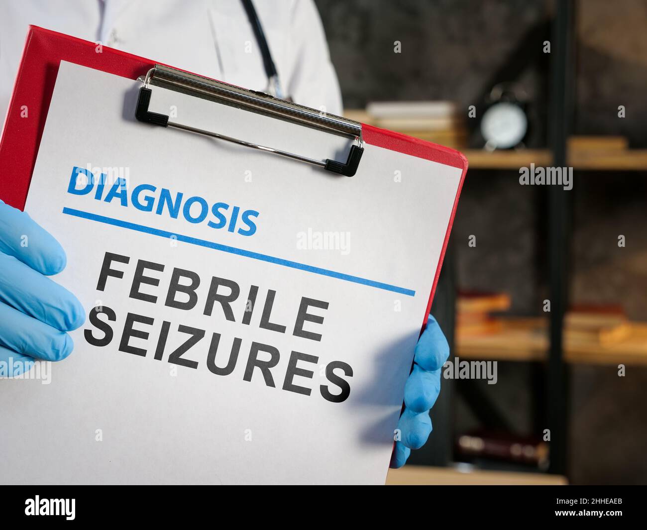Doctor shows diagnosis febrile seizures on the medic form. Stock Photo